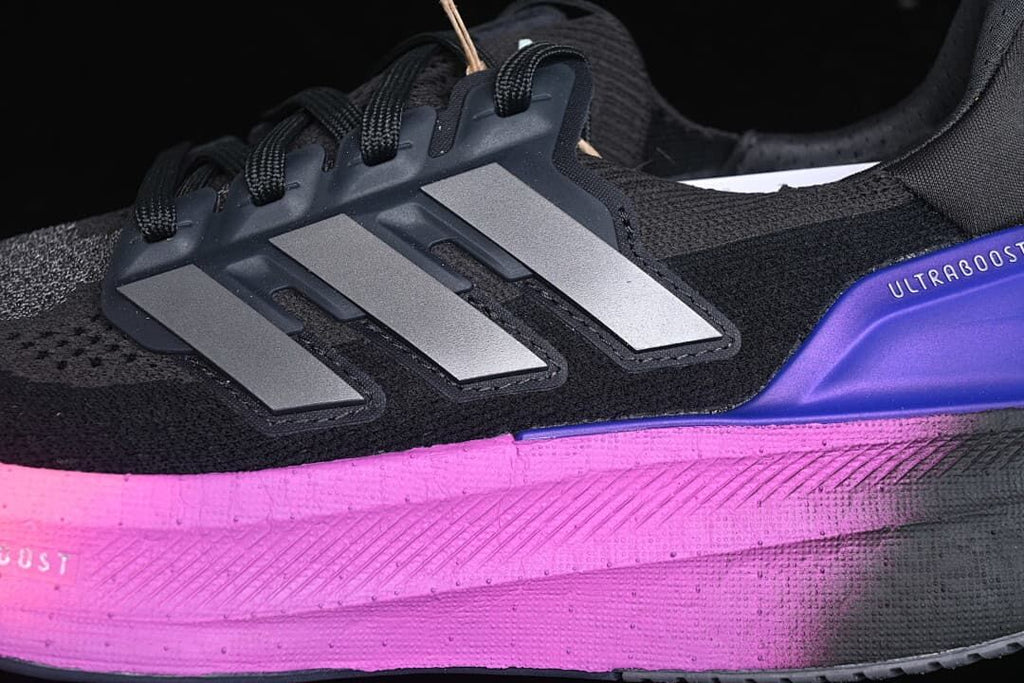 Close-up of side stripes, laces, and pink midsole accent