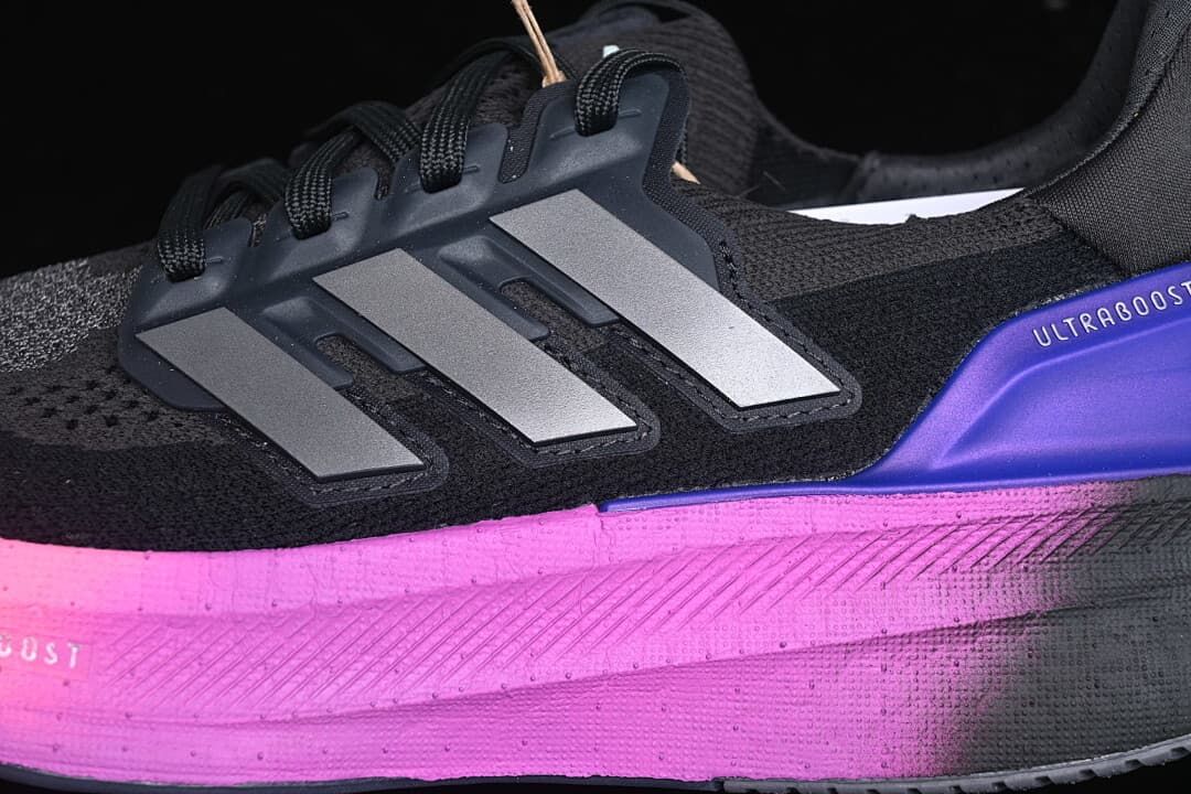 Close-up of side stripes, laces, and pink midsole accent