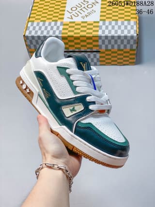 Side view of a green-and-white low-top sneaker with layered panels and contrast laces.