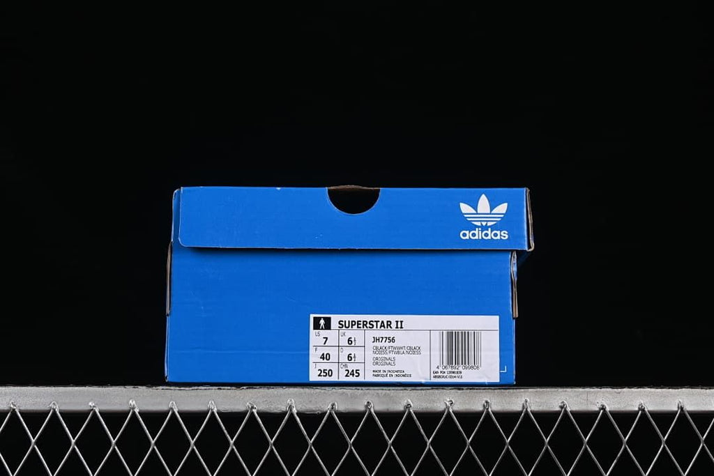 Blue Adidas shoe box with a label identifying the Superstar II JH7756 and sample size details