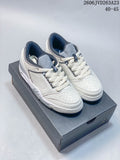 Pair of white Jordan Sixty Plus Low sneakers with gray and navy accents, shown on a shoebox