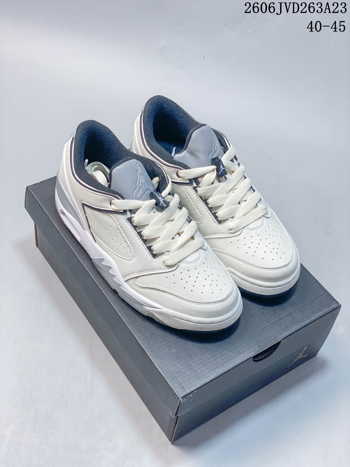 Pair of white Jordan Sixty Plus Low sneakers with gray and navy accents, shown on a shoebox