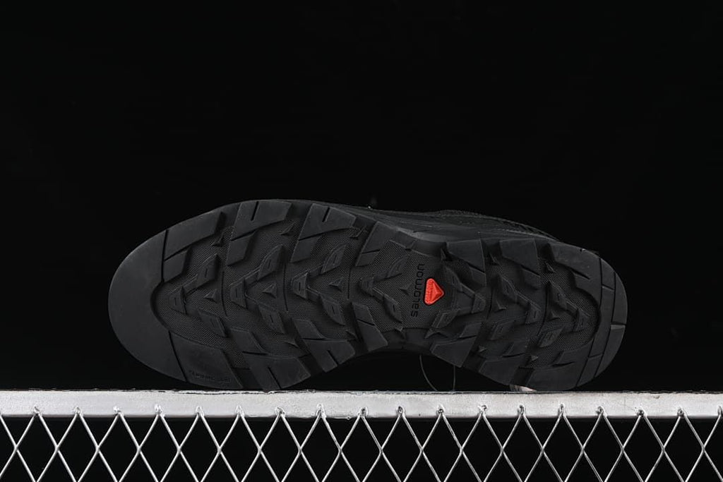 Underside showing the lugged outsole and red central detail