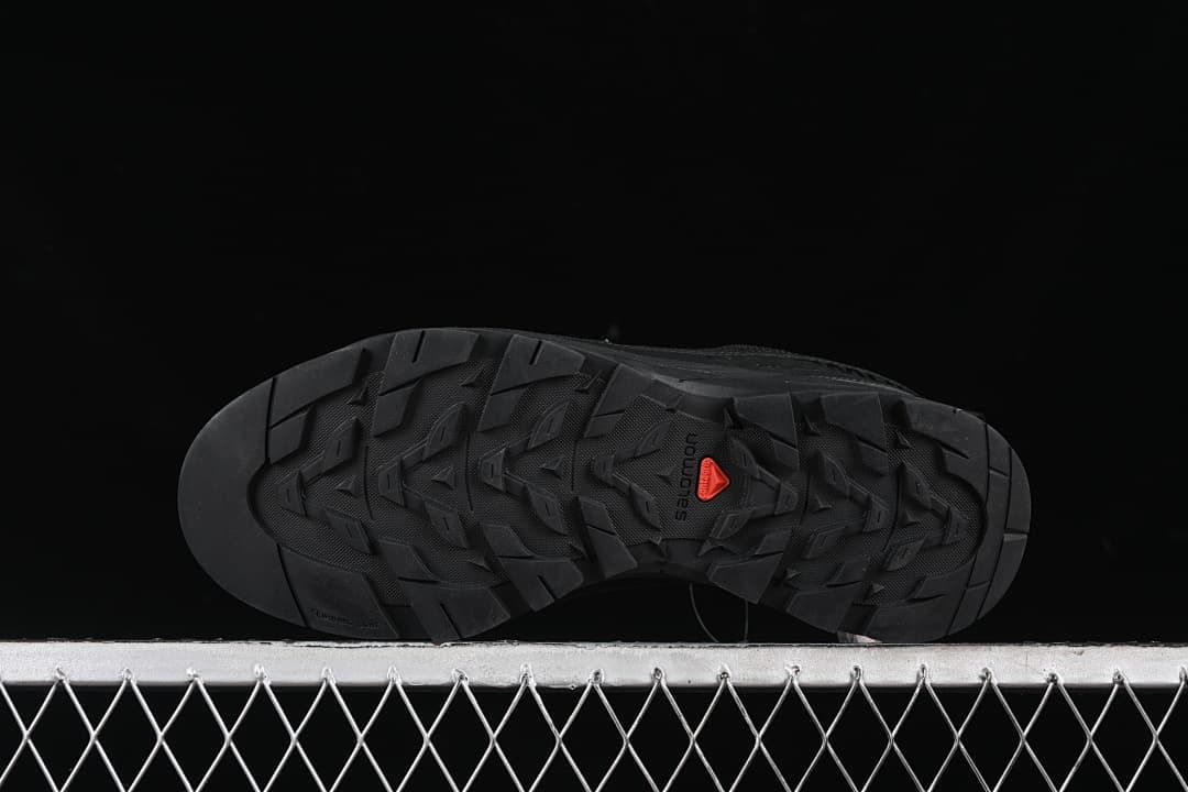 Underside showing the lugged outsole and red central detail