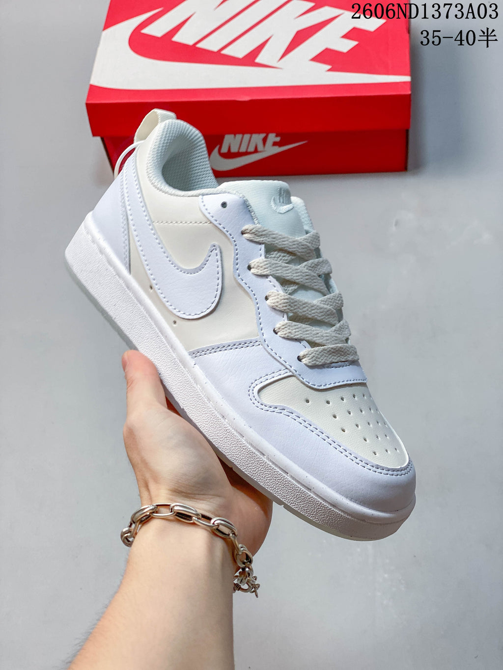 Angled side view of the white and pale blue sneaker