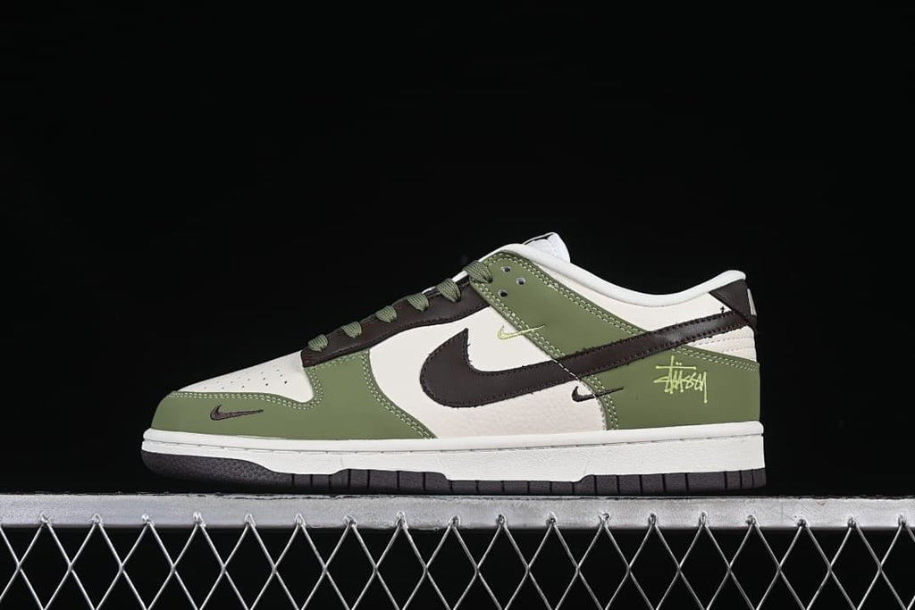 Side view of olive green, off-white, and dark brown low-top sneakers