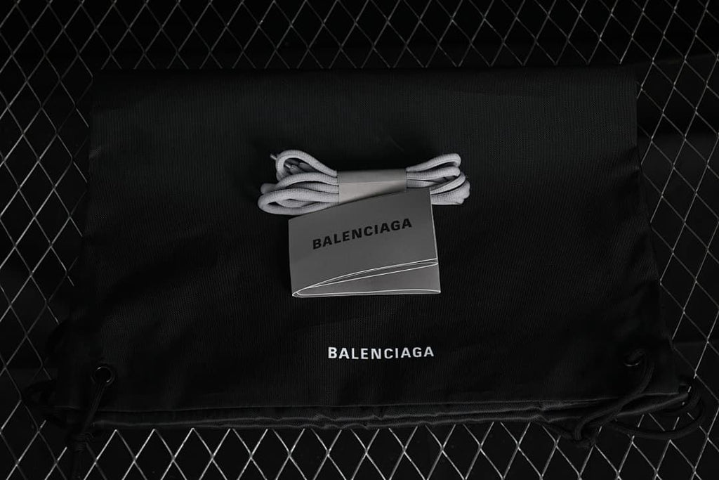 Black drawstring bag and spare grey laces shown with a branded card