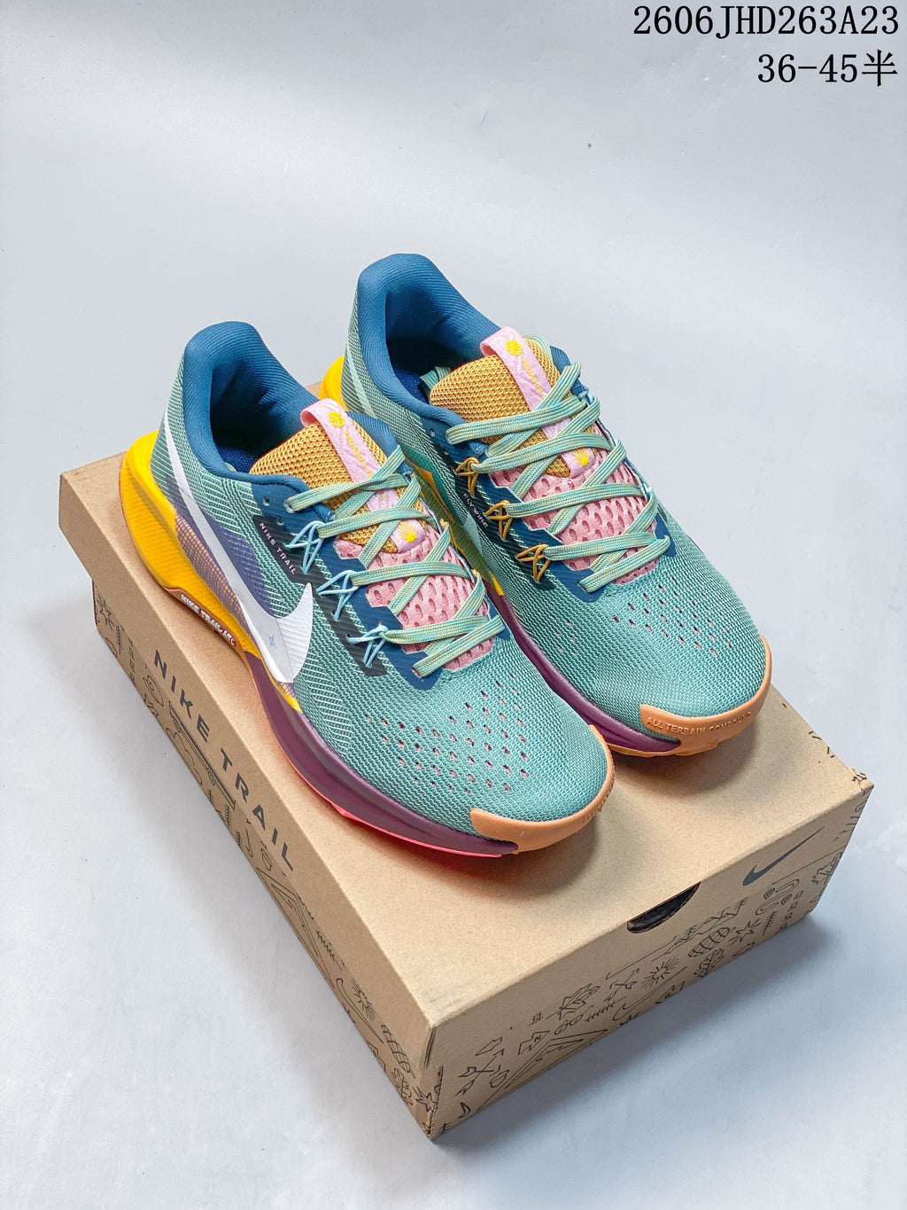 Pair of teal Nike Pegasus Trail 5 trail running shoes on a Nike Trail box.
