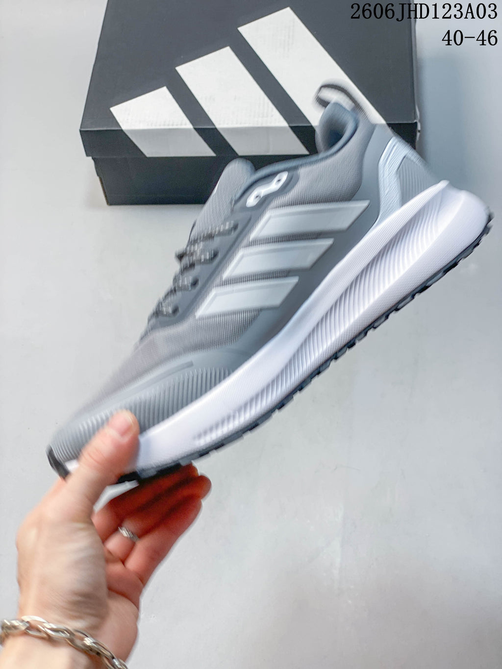 Side view of a grey Adidas Runfalcon 5 TR shoe with white stripes