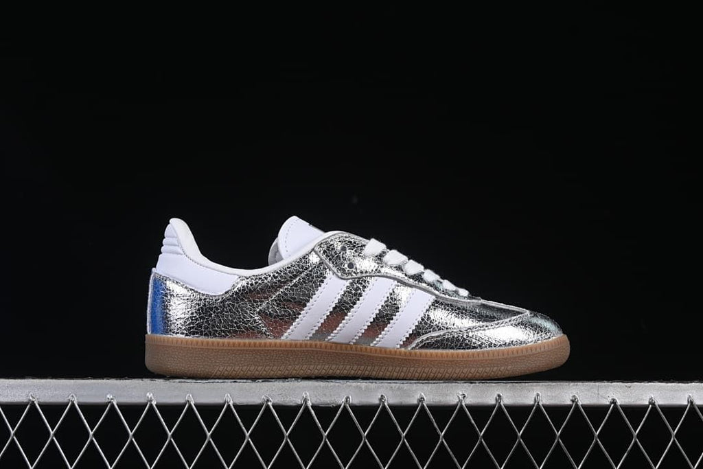 Side profile of a silver-toned Samba OG sneaker
