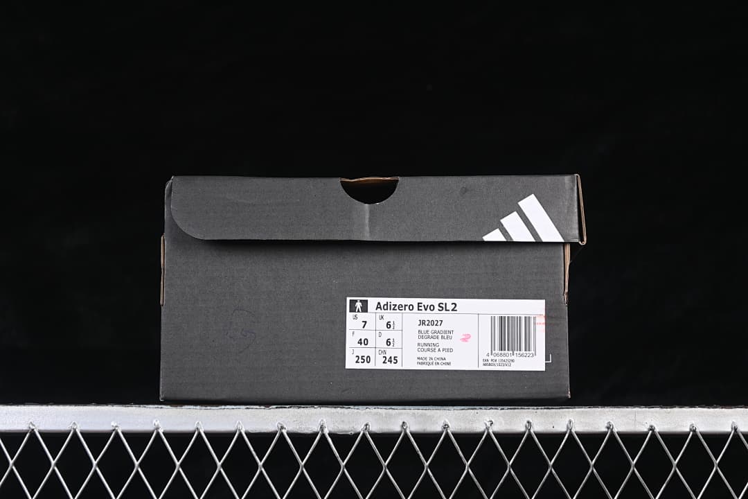adidas shoebox with a label identifying the Adizero Evo SL2 and sample size details.