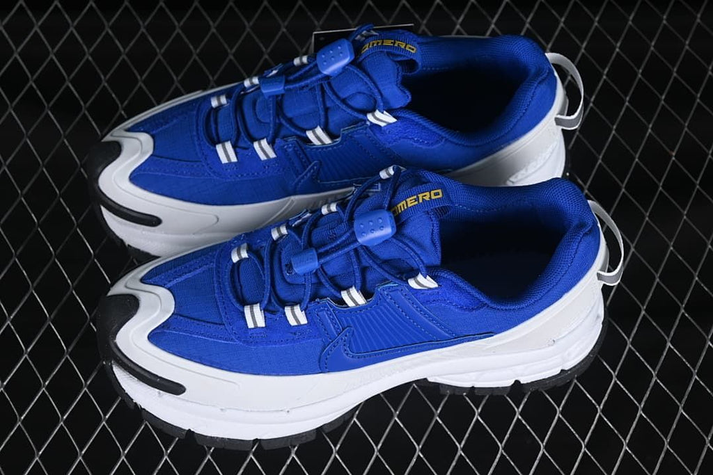 Pair of blue Nike Zoom Vomero Roam sneakers with white midsoles and black outsole accents