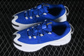 Pair of blue Nike Zoom Vomero Roam sneakers with white midsoles and black outsole accents
