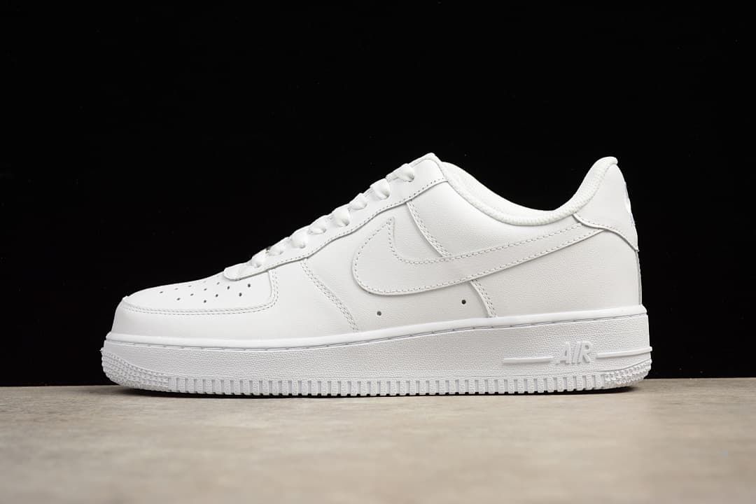 White low-top sneaker shown in side profile against a black background.