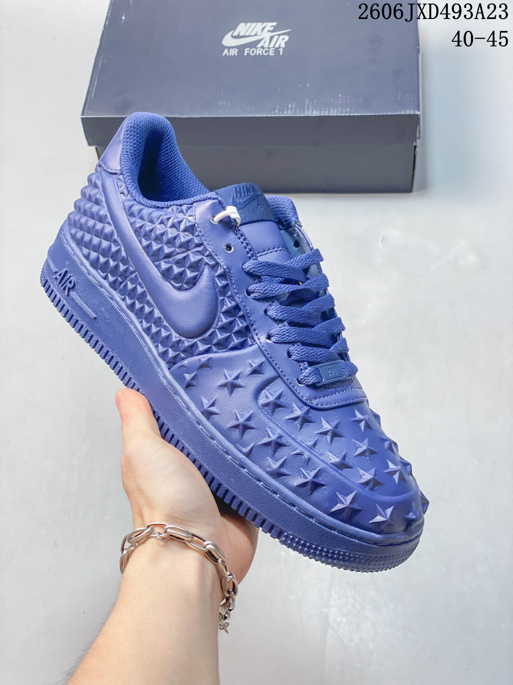 Close view of a blue star-textured sneaker with side Swoosh and ridged sole