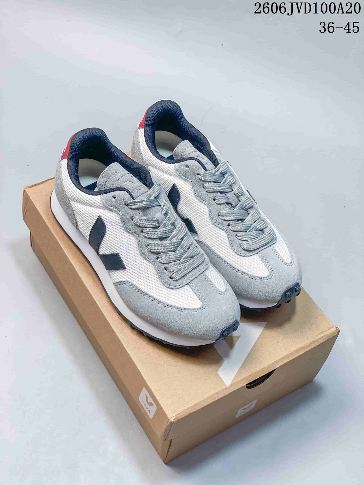 Pair of white, grey, and navy Veja low-top sneakers on a box; image overlay reads 36–45.
