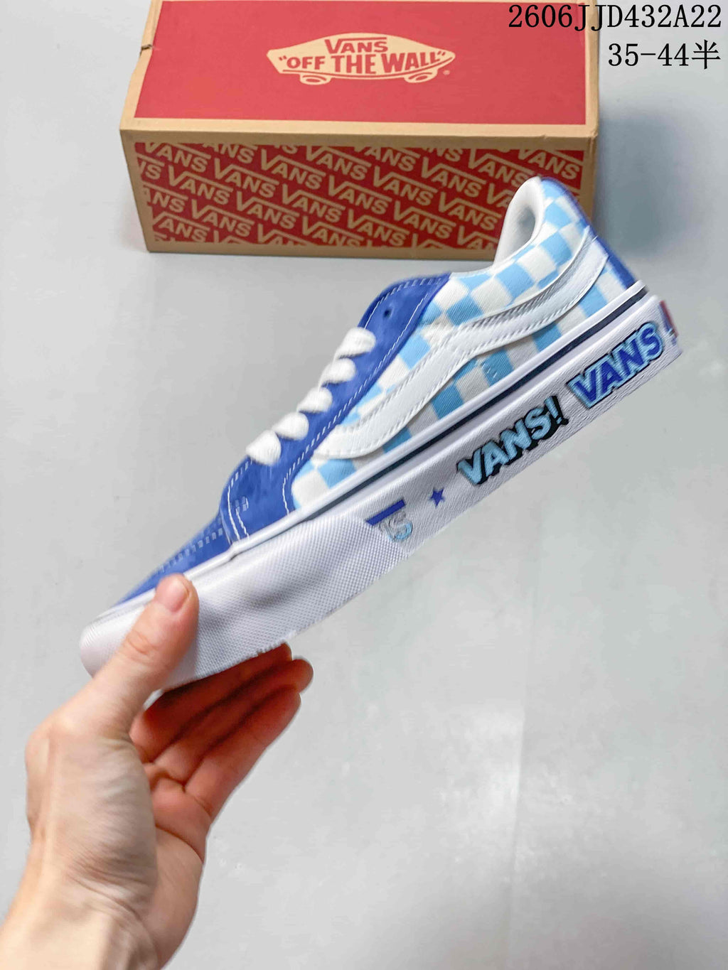 Side view of the blue and white checkerboard sneaker with graphic midsole lettering