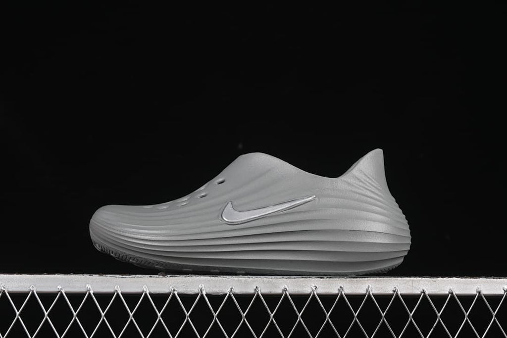 Side view of a grey Nike ReactX Rejuven8 clog sandal