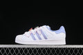 Side view of white adidas Superstar II sneakers with pastel iridescent stripes and pink lace details