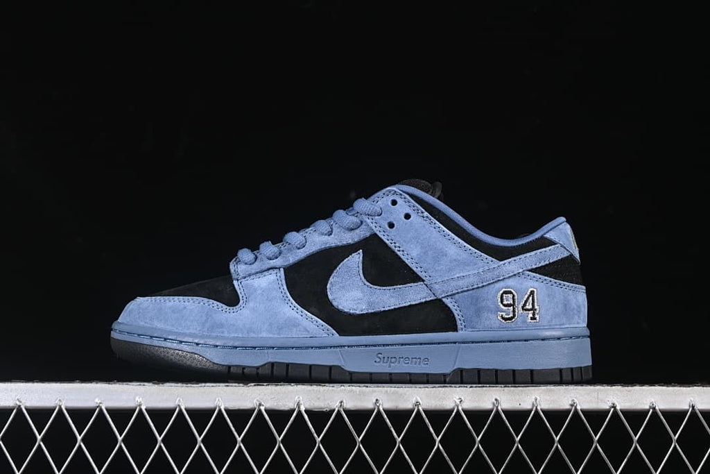 Side profile of the blue and black Nike SB Dunk Low with 94 heel detail