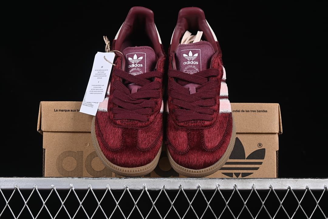 Front view of the pair displayed on an Adidas-branded box