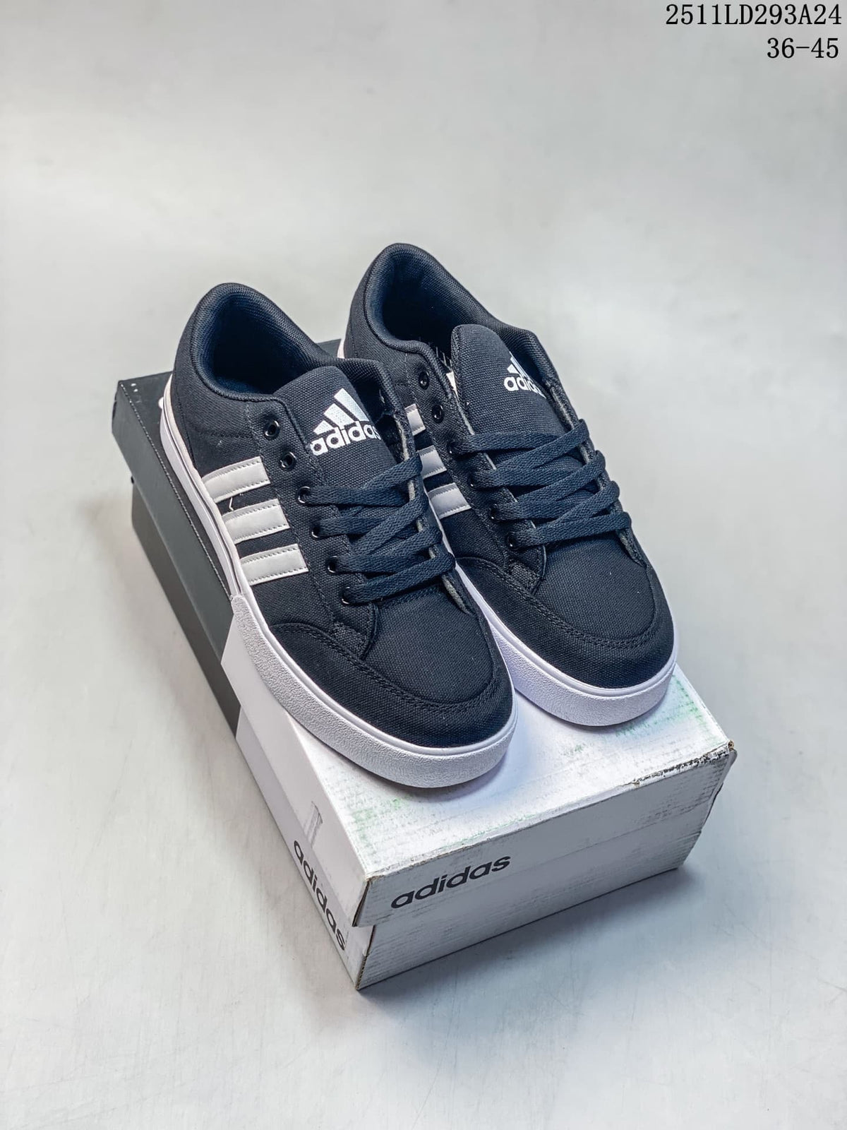Pair of navy Adidas GVP Canvas STR low-top sneakers with white stripes and soles, shown on a shoebox.