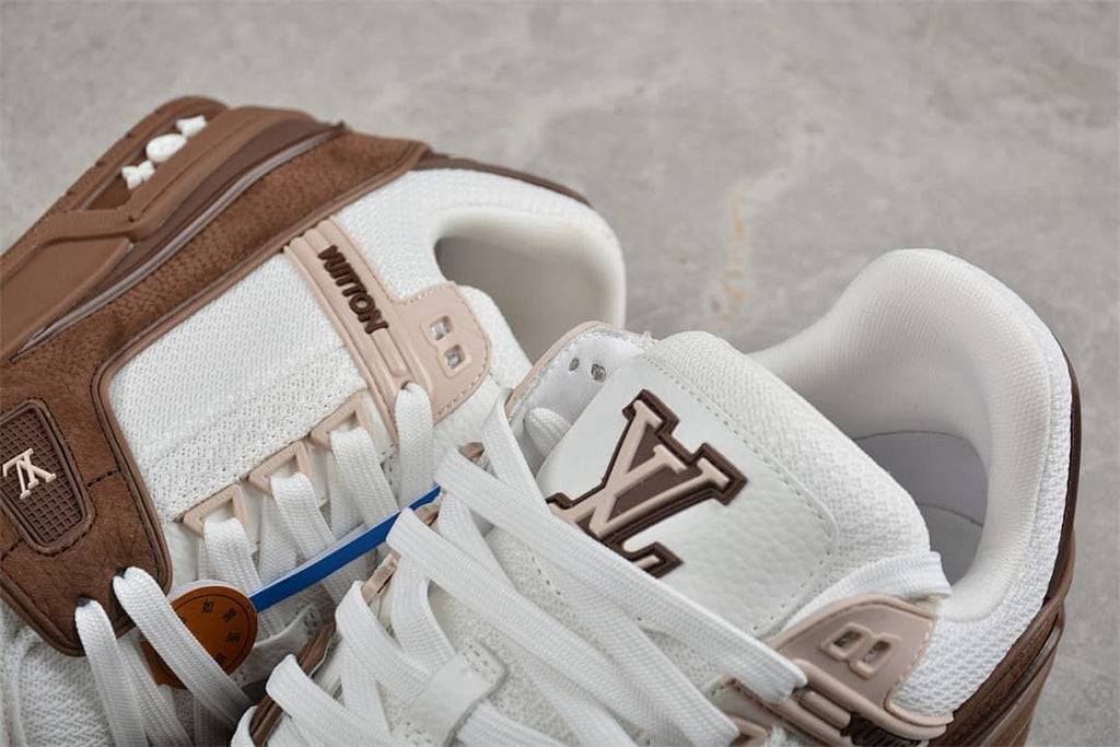 Close-up of the white laces, tongue logo, and brown side details.