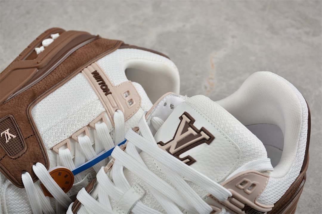 Close-up of the white laces, tongue logo, and brown side details.