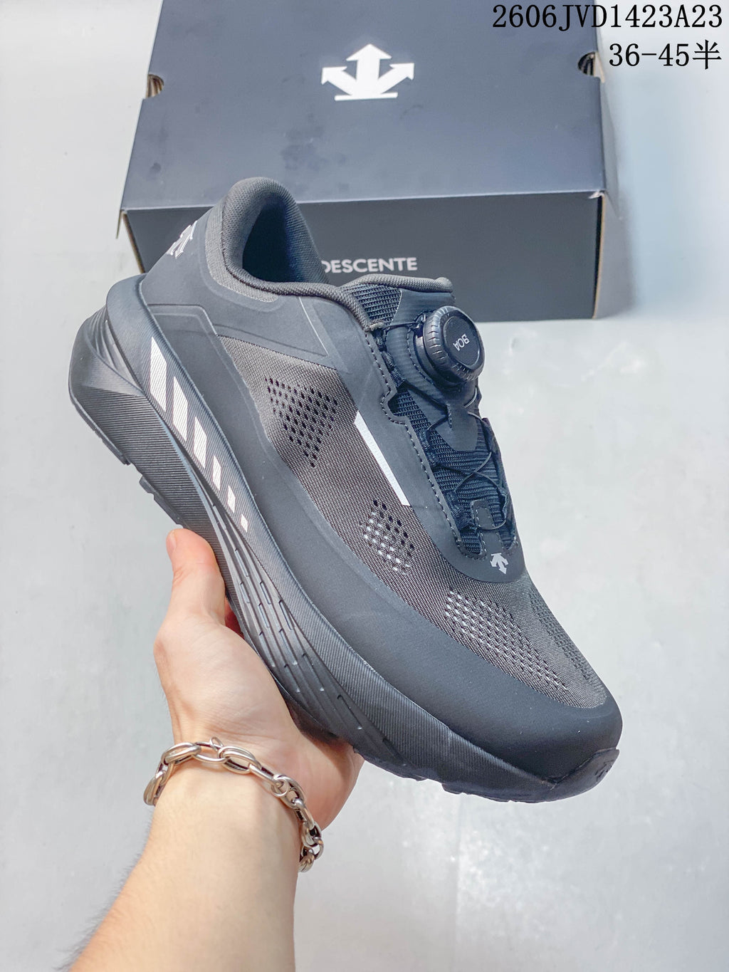 Angled side view of the charcoal sneaker with light side accents.