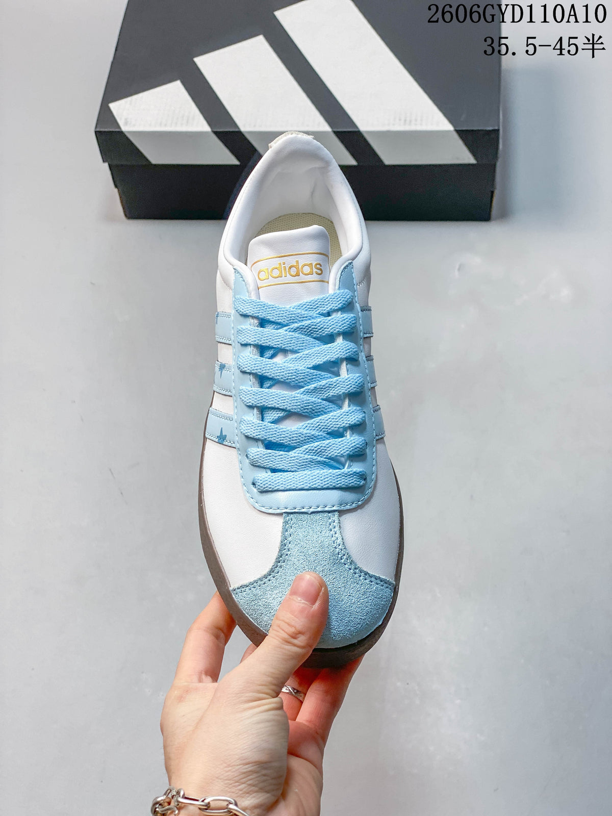 Front view of the sneaker with light-blue laces and toe detail