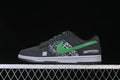 Side view of black low-top sneakers with a green Swoosh, patterned side panels, and white midsole