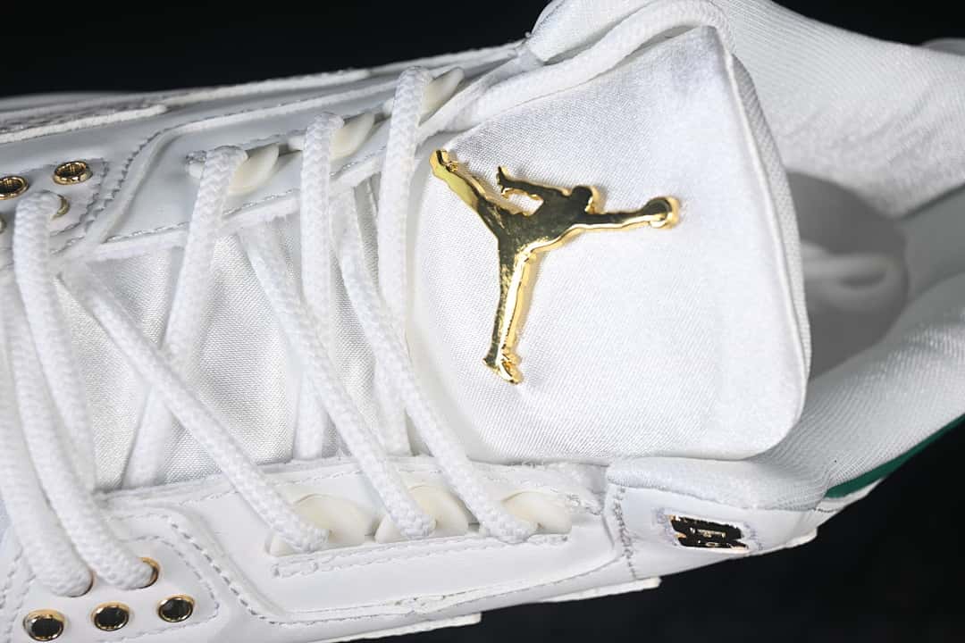 Close-up of the tongue with a gold-tone emblem and white laces