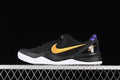 Side view of a black Nike Kobe 8 Protro shoe with gold Swoosh, purple heel accents and white outsole