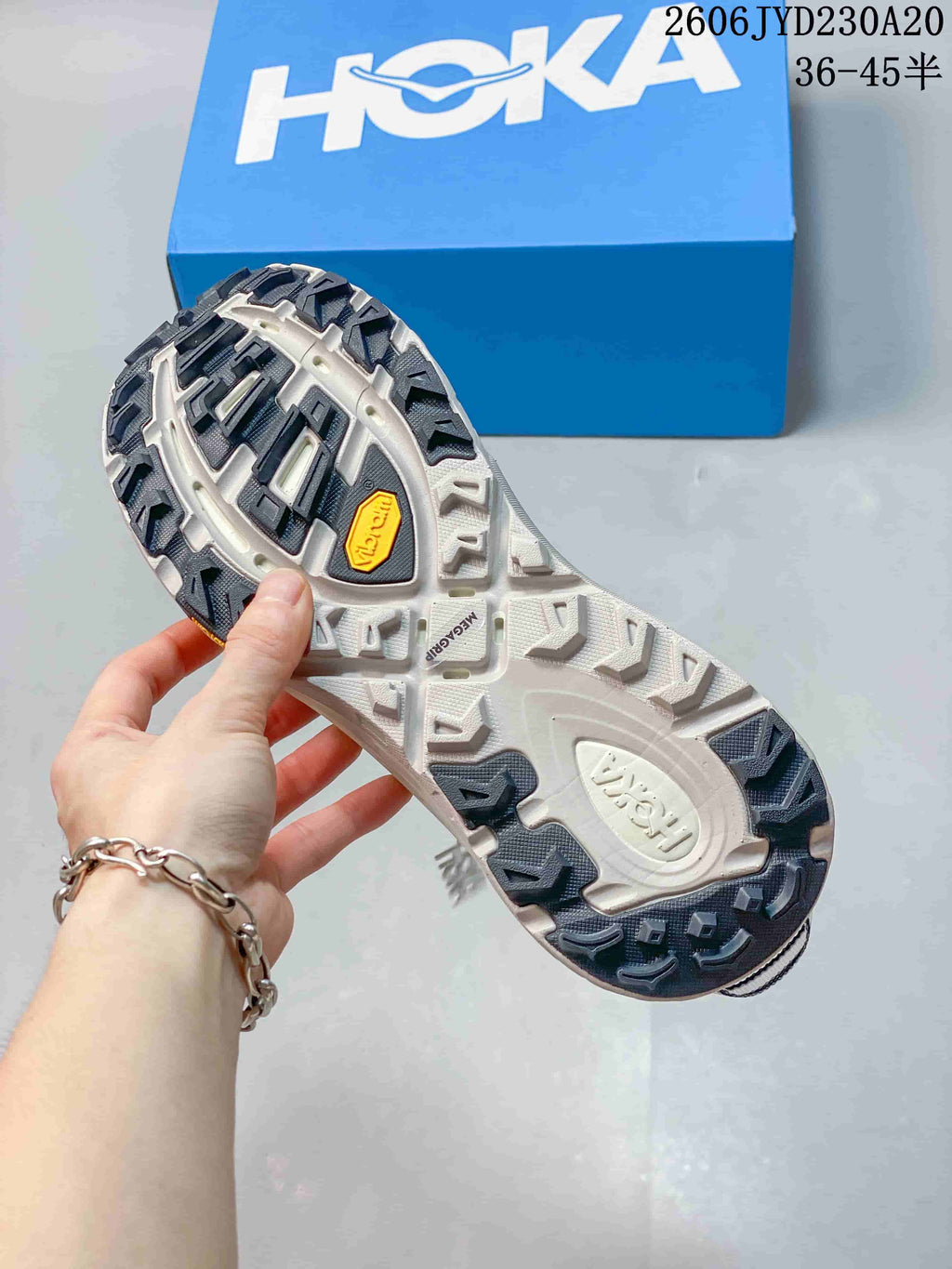 Underside of a running shoe showing a lugged outsole and Vibram marking