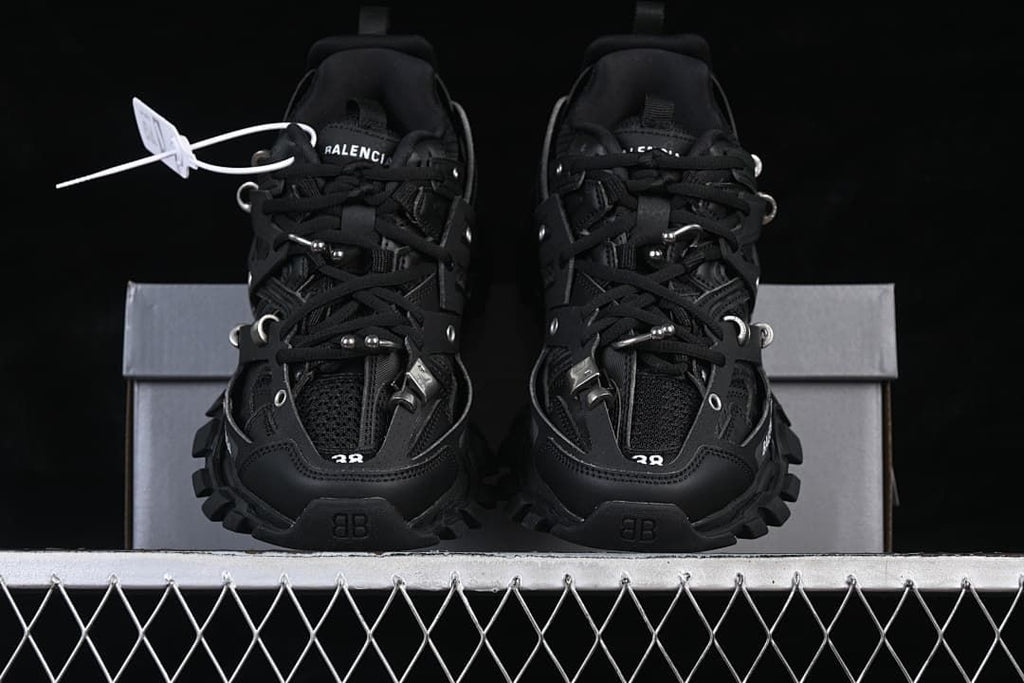 Front view of the pair of black sneakers