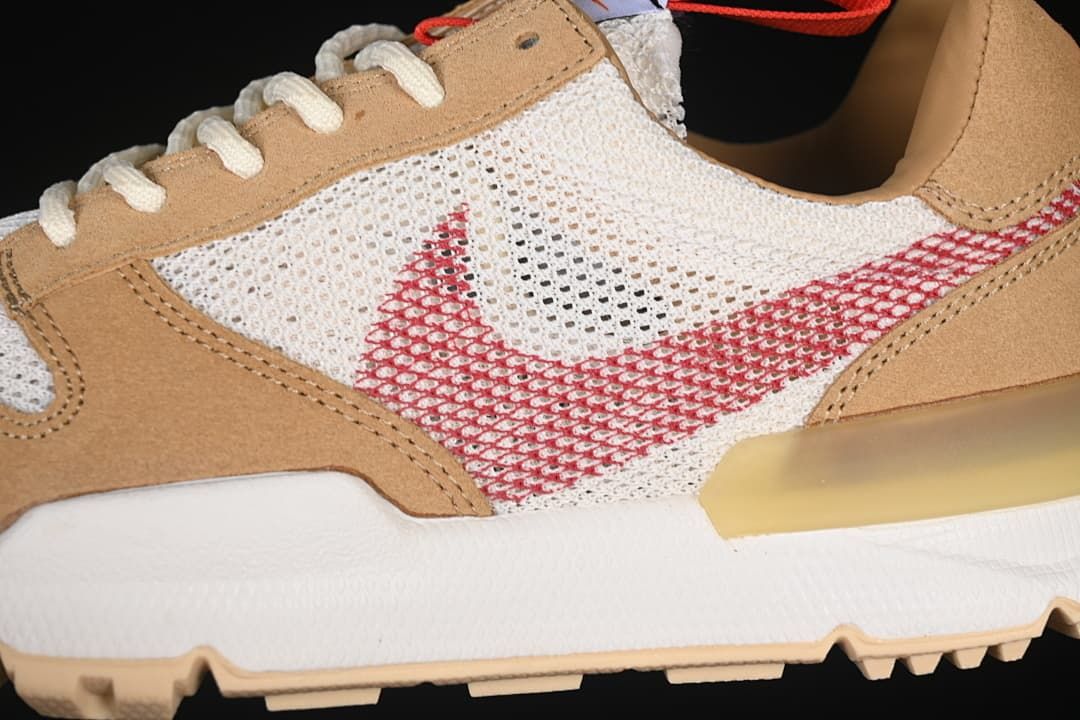 Close-up of mesh side panel, red Swoosh, tan overlays, and white midsole