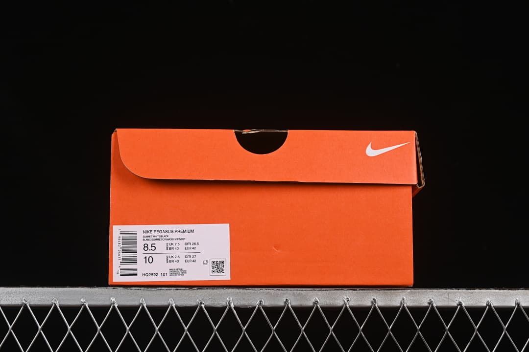 Orange shoe box with Nike Pegasus Premium label and style code HQ2592 101.