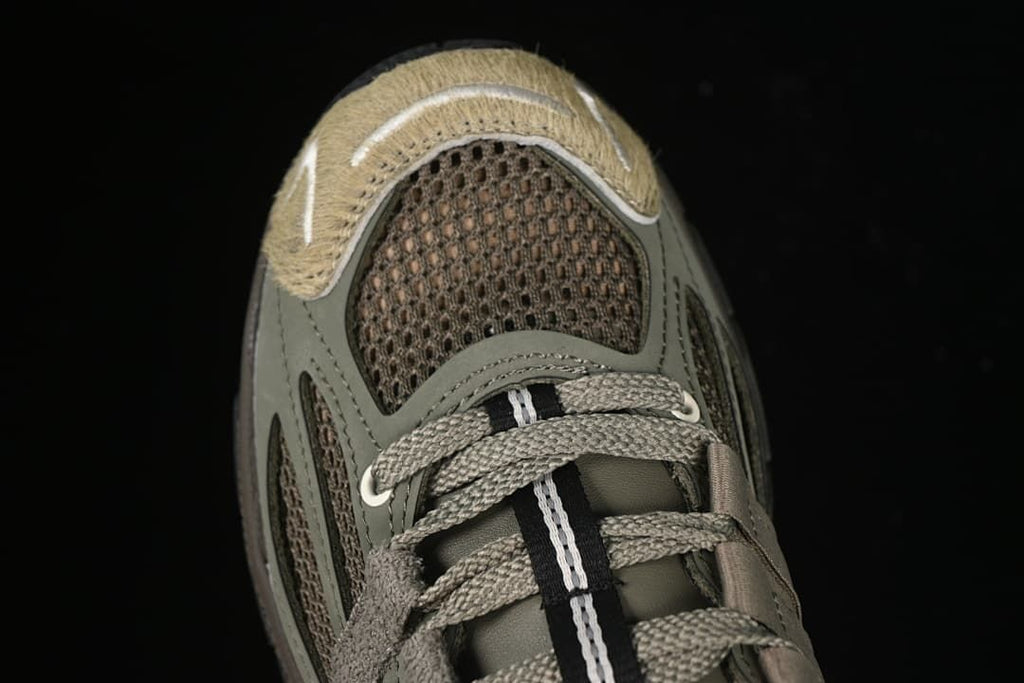 Top view of the sneaker showing the mesh toe, laces and layered panels.
