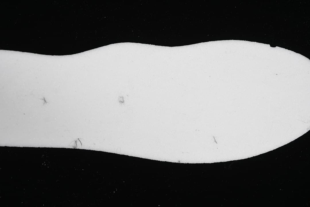 White shoe insert shown separately against a dark background