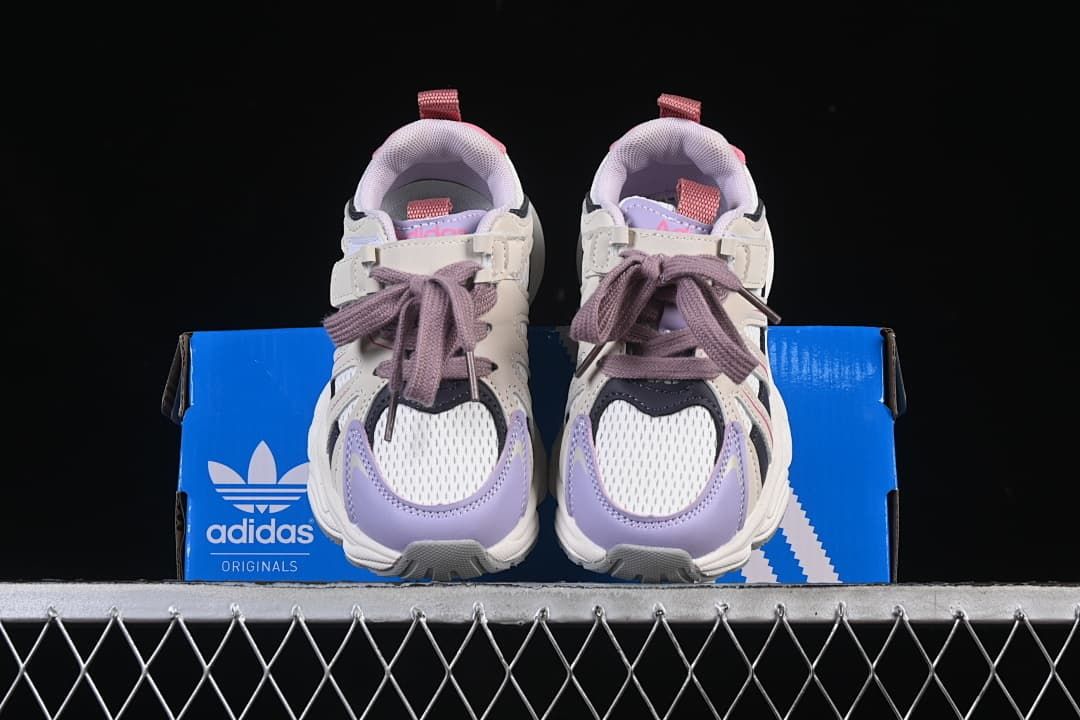 Front view of the pair displayed on an adidas box
