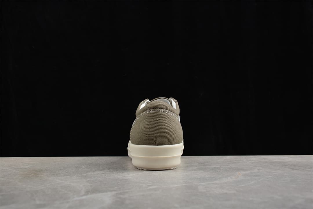 Rear view of a brown canvas sneaker with an off-white sole