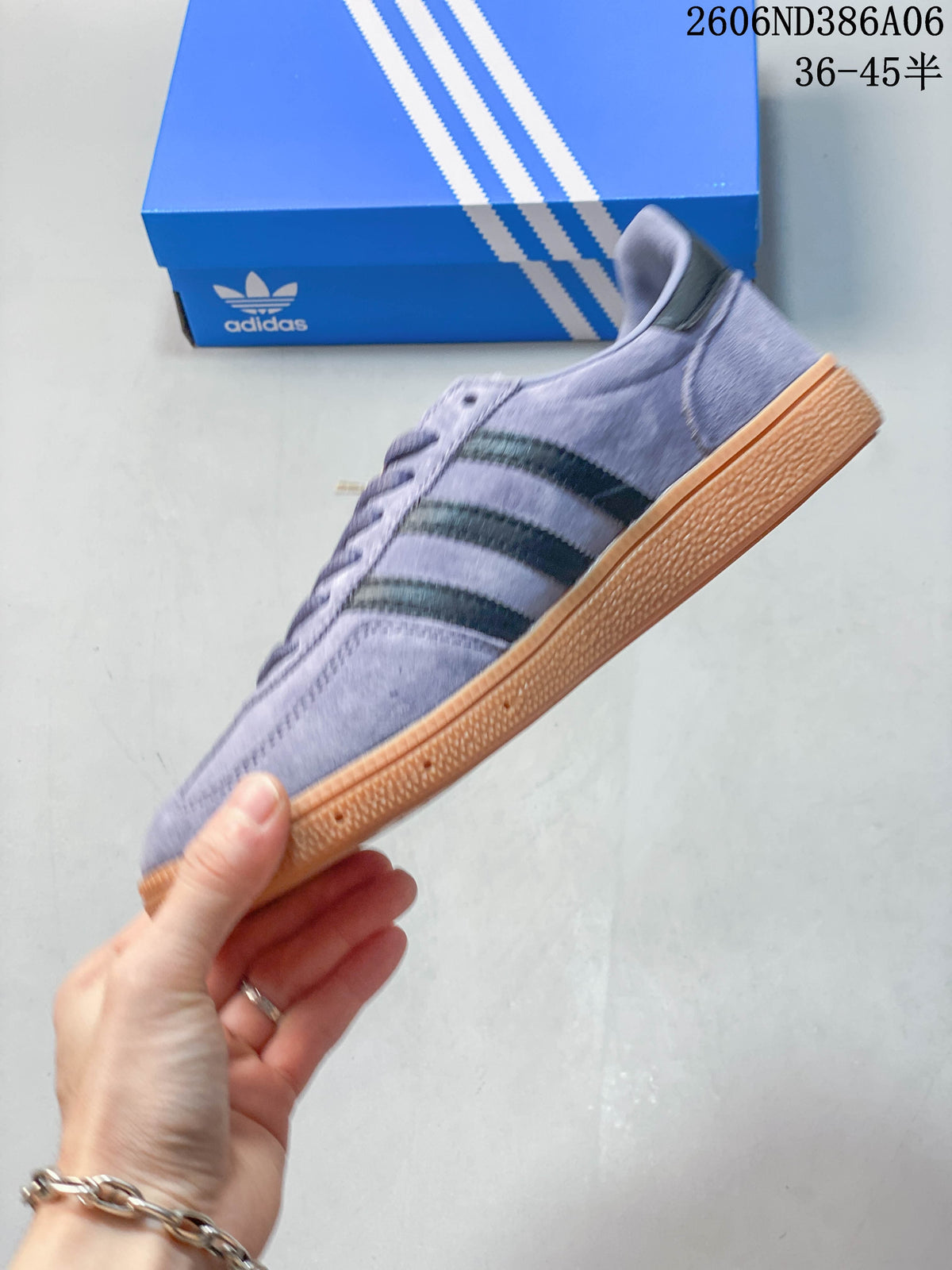 Side view of the lavender low-top sneaker with dark stripes and gum-colored sole