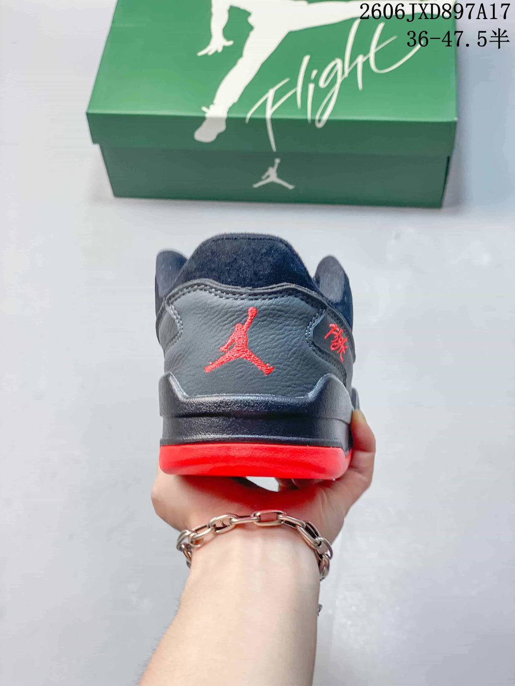 Rear view of a dark Jordan Flight Court shoe with red heel details