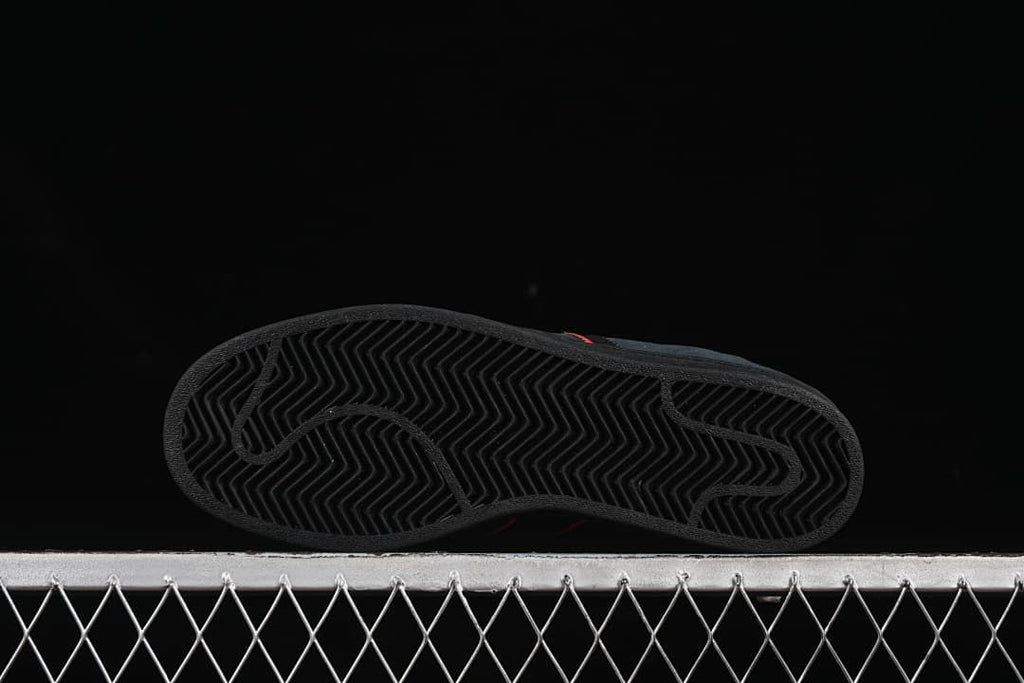 View of the black outsole with a herringbone tread pattern