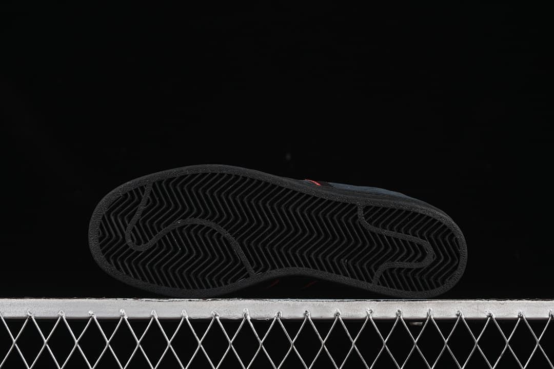 View of the black outsole with a herringbone tread pattern