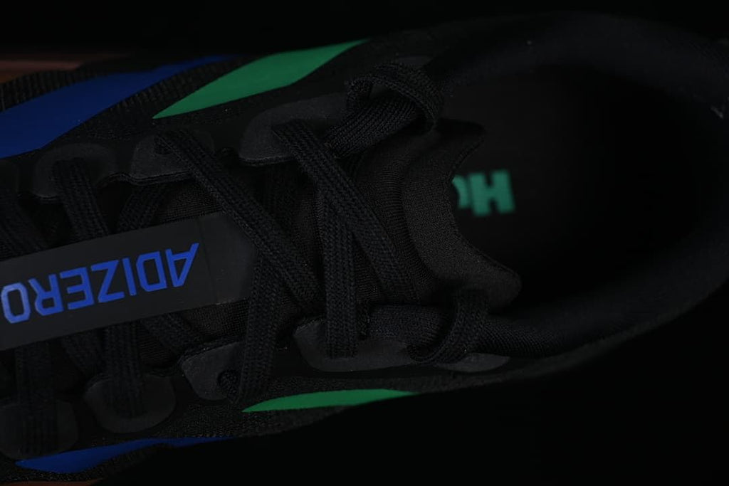 Top-down close-up of the black laces and Adizero tongue label.