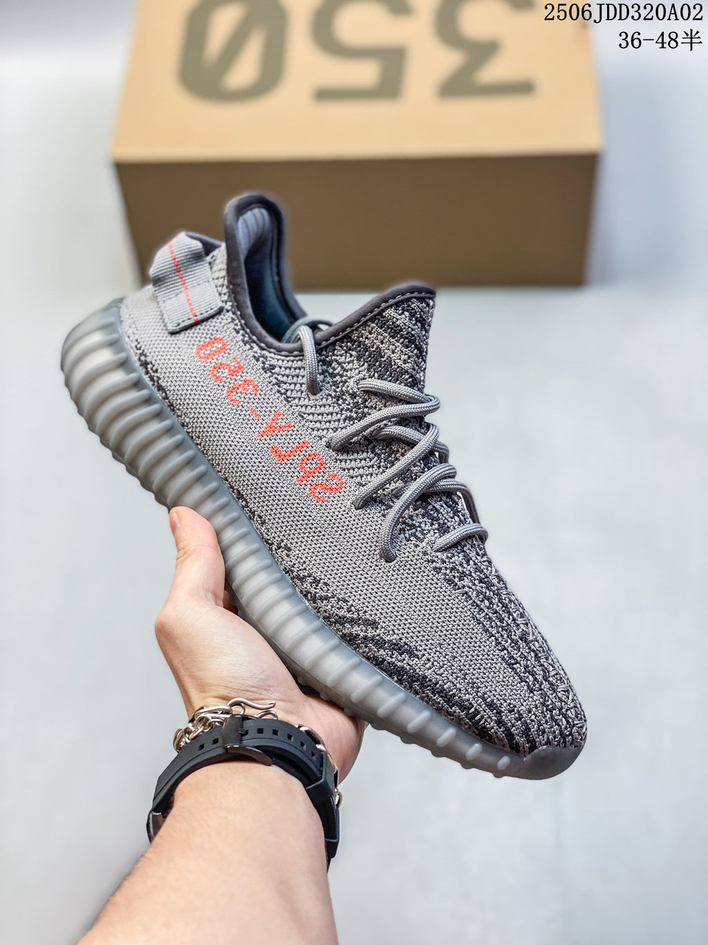 Gray Adidas Yeezy-style sneaker with orange lettering and a translucent-looking sole