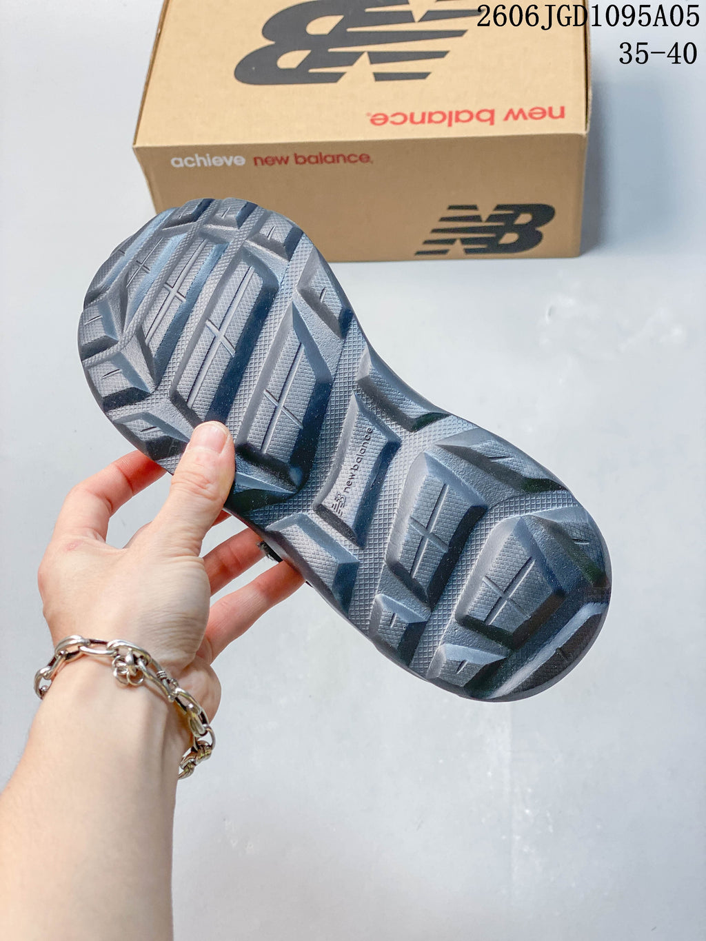 Close-up of the patterned outsole on a gray New Balance Breeze sneaker