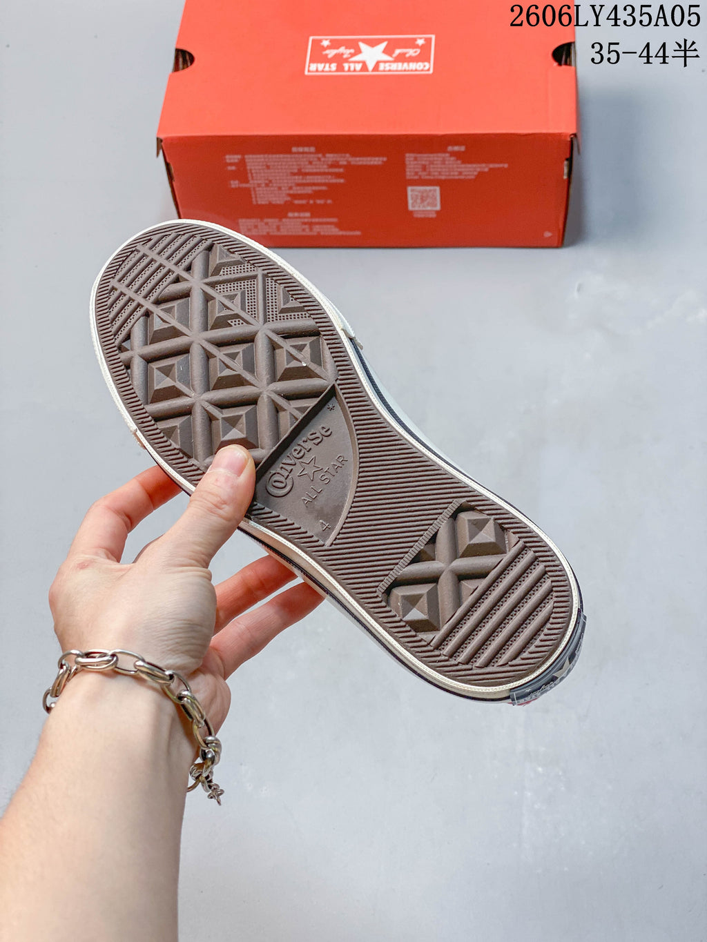 View of the patterned outsole on a pink high-top sneaker