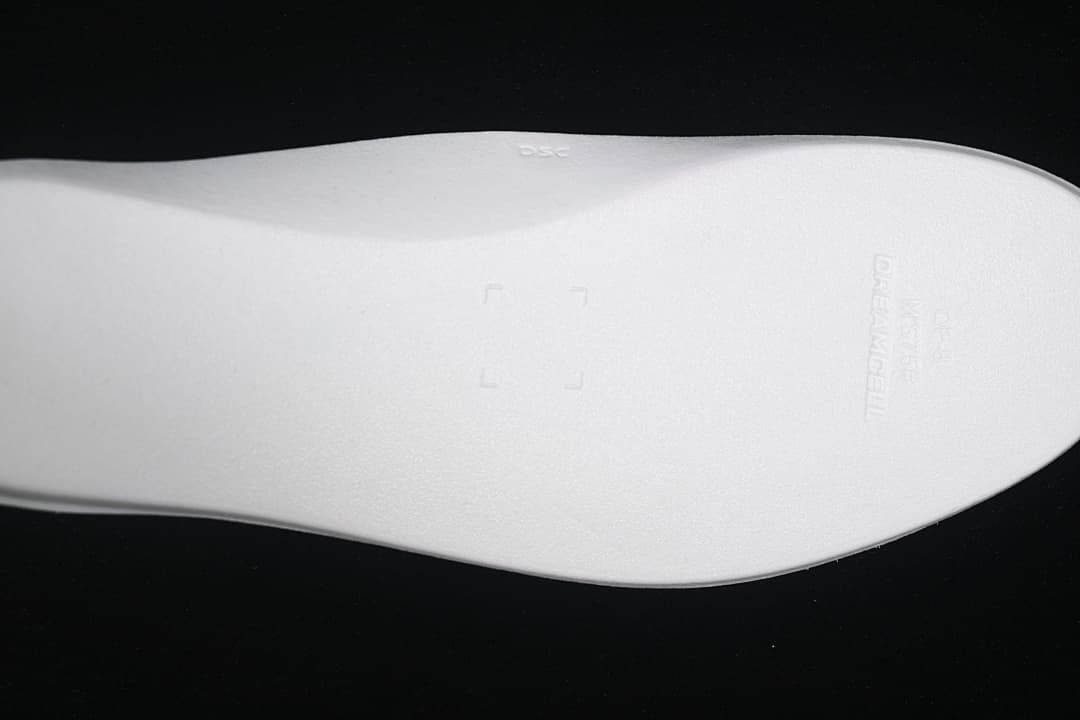 Close-up of the light-colored insole with embossed branding